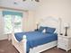 Bright main bedroom features a bed with a blue comforter, and an arched headboard at 8712 Attingham Dr, Raleigh, NC 27615