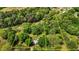Aerial view shows home set on large wooded lot, indicated by yellow property lines at 901D Gibson Rd, Mebane, NC 27302