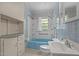 Bathroom showcasing blue tiled walls, turquoise tub, and white fixtures at 901D Gibson Rd, Mebane, NC 27302