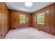 Bedroom featuring wood paneling, lots of natural light and neutral carpet at 901D Gibson Rd, Mebane, NC 27302