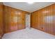 Bedroom featuring wood paneling, neutral carpet, and doorway leading to another room at 901D Gibson Rd, Mebane, NC 27302