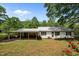 Home's inviting exterior features a carport and brick foundation, nestled in a lush green yard at 901D Gibson Rd, Mebane, NC 27302