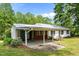 Charming home featuring a carport and brick foundation, nestled in a serene, green yard at 901D Gibson Rd, Mebane, NC 27302