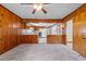 Bright living room leading into kitchen, featuring wood paneling and view of modern appliances at 901D Gibson Rd, Mebane, NC 27302