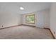 Bare living room features a window and carpeted floors at 901D Gibson Rd, Mebane, NC 27302