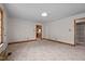 Inviting living room with carpet floors, textured ceiling, and natural wood trim at 901D Gibson Rd, Mebane, NC 27302