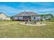 Landscaped backyard with a fire pit and seating area, perfect for outdoor gatherings and relaxation at 93 Fallingbrook Dr, Kenly, NC 27542