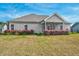 Expansive backyard featuring lush landscaping and a well-maintained lawn, ideal for outdoor activities at 93 Fallingbrook Dr, Kenly, NC 27542