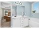 Stylish bathroom featuring double vanity, bathtub and view to the main bedroom at 93 Fallingbrook Dr, Kenly, NC 27542