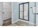 Modern bathroom featuring a tiled shower with a glass door and a spacious walk-in closet at 93 Fallingbrook Dr, Kenly, NC 27542