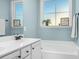 Bright bathroom featuring a bathtub and a vanity with white countertops at 93 Fallingbrook Dr, Kenly, NC 27542