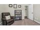 Inviting bedroom with a comfy chair, bookshelf, and view into another room, perfect for relaxation and reading at 93 Fallingbrook Dr, Kenly, NC 27542