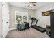 Bedroom with neutral walls and carpet, a desk, and a treadmill, offering functionality and space for exercise at 93 Fallingbrook Dr, Kenly, NC 27542