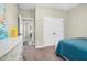 Cozy bedroom with neutral walls, white trim, a large closet, and doorway to an additional room at 93 Fallingbrook Dr, Kenly, NC 27542