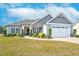 Charming single-Gathering home with manicured lawn, inviting front door, and attached two-car garage at 93 Fallingbrook Dr, Kenly, NC 27542