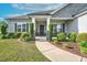 Inviting front porch with decorative plants, and a 'Welcome' sign offering a warm entrance at 93 Fallingbrook Dr, Kenly, NC 27542