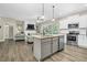 Open kitchen with island, stainless appliances, and seamless flow to the living area at 93 Fallingbrook Dr, Kenly, NC 27542