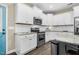 Bright kitchen featuring white cabinets, stainless steel appliances, and granite countertops at 93 Fallingbrook Dr, Kenly, NC 27542