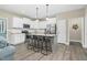 Modern kitchen featuring white cabinets, granite countertops, stainless steel appliances and seating at the island at 93 Fallingbrook Dr, Kenly, NC 27542