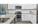 Well-equipped kitchen with stainless steel appliances, white cabinets, and granite countertops at 93 Fallingbrook Dr, Kenly, NC 27542