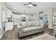 Open-concept design with a comfortable sofa and a view of the modern kitchen and dining area at 93 Fallingbrook Dr, Kenly, NC 27542