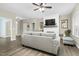 Spacious living room featuring hardwood floors, shiplap fireplace, and modern ceiling fan at 93 Fallingbrook Dr, Kenly, NC 27542
