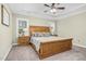 Spacious main bedroom with tray ceiling, ceiling fan, and cozy decor at 93 Fallingbrook Dr, Kenly, NC 27542