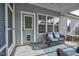 Cozy screened porch with comfortable seating and an exterior door, creating a relaxing outdoor living space at 93 Fallingbrook Dr, Kenly, NC 27542