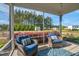 Relaxing screened porch with comfortable seating and a view of the spacious, well-maintained backyard at 93 Fallingbrook Dr, Kenly, NC 27542