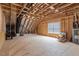 Unfinished attic with exposed wood framing, a window, insulation, and plenty of potential at 101 Jewell Farm Lane, Holly Springs, NC 27540