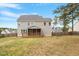 Large backyard features a wooden porch, lush lawn, and a privacy fence, perfect for outdoor activities and relaxation at 101 Jewell Farm Lane, Holly Springs, NC 27540