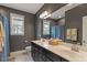 The bathroom is equipped with a double sink vanity, toilet, framed mirror and shower curtain at 101 Jewell Farm Lane, Holly Springs, NC 27540