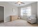 Bright bedroom with neutral colors and a comfortable armchair at 101 Jewell Farm Lane, Holly Springs, NC 27540