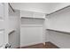 Walk-in closet with shelving and rods for ample storage at 101 Jewell Farm Lane, Holly Springs, NC 27540