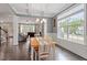 Inviting dining area with coffered ceilings, hardwood floors, and large windows, perfect for Gathering gatherings and dinner parties at 101 Jewell Farm Lane, Holly Springs, NC 27540