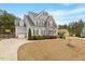 Lovely two-story home with attached garage and basketball hoop, set on a well-maintained lawn and manicured landscape at 101 Jewell Farm Lane, Holly Springs, NC 27540