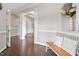 Bright foyer featuring hardwood floors, decorative columns, bench seating, and an open floor plan perfect for entertaining at 101 Jewell Farm Lane, Holly Springs, NC 27540