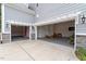 Three-car garage with automatic doors, a grey epoxy floor, and stone accents at 101 Jewell Farm Lane, Holly Springs, NC 27540