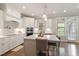 Well-equipped kitchen featuring a center island with barstool seating, appliances and pendant lighting at 101 Jewell Farm Lane, Holly Springs, NC 27540