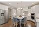 Spacious kitchen with stainless steel appliances, center island, white cabinets, and hardwood flooring at 101 Jewell Farm Lane, Holly Springs, NC 27540