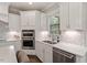 Close-up of the white kitchen counters and tile backsplash at 101 Jewell Farm Lane, Holly Springs, NC 27540