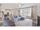 Spacious living room with a large sectional, hardwood floors, and a view of the kitchen, perfect for gatherings at 101 Jewell Farm Lane, Holly Springs, NC 27540