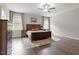 Main bedroom featuring hardwood floors, neutral paint, and large windows at 101 Jewell Farm Lane, Holly Springs, NC 27540