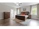 Primary bedroom showcasing hardwood floors and ample windows at 101 Jewell Farm Lane, Holly Springs, NC 27540