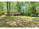 Spacious backyard with lush trees and landscaping, featuring a deck and brick accents at 104 Argyle Ct, Garner, NC 27529
