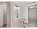 Bathroom with white cabinet vanity, commode, and light fixture at 104 Argyle Ct, Garner, NC 27529