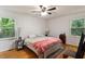Cozy bedroom with hardwood floors, two windows, and comfortable furnishings creates a relaxing retreat at 104 Argyle Ct, Garner, NC 27529