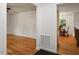 Open hallway showcases hardwood floors leading to the living room and dining area with natural light at 104 Argyle Ct, Garner, NC 27529