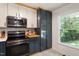 Modern kitchen with stainless steel appliances and a view of the outdoors through the window at 104 Argyle Ct, Garner, NC 27529