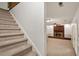 View of the living room from the stairs with a brick fireplace and light colored carpet at 104 Argyle Ct, Garner, NC 27529